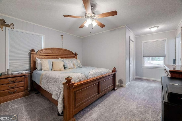 carpeted bedroom with a textured ceiling, ceiling fan, and crown molding