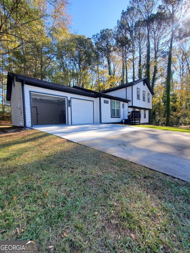 view of front of home featuring a garage and a front lawn