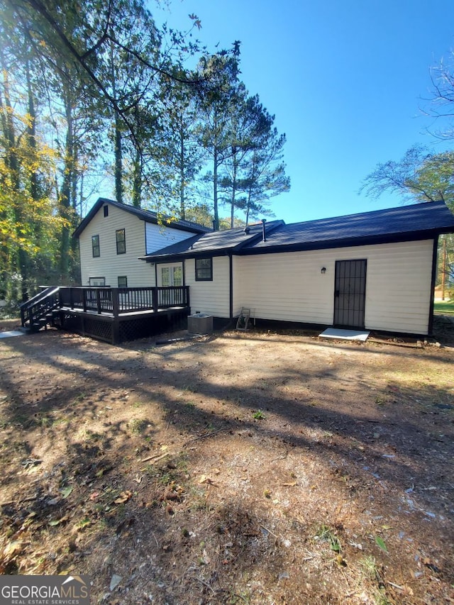 back of house with a deck