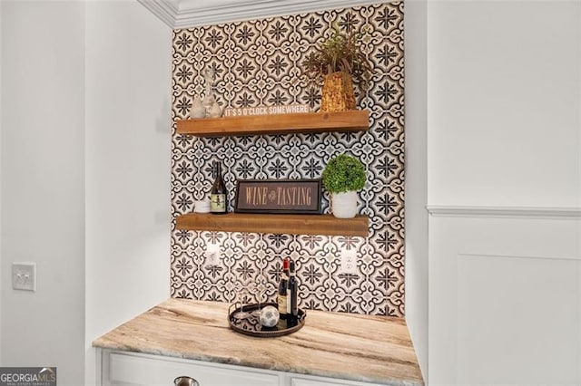 room details featuring ornamental molding and tasteful backsplash