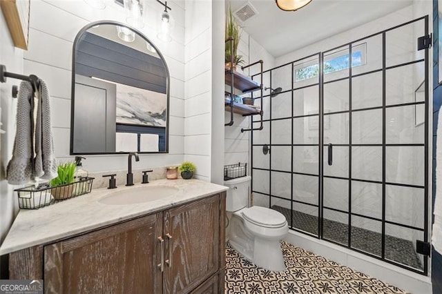 bathroom featuring tiled shower, vanity, tile walls, and toilet