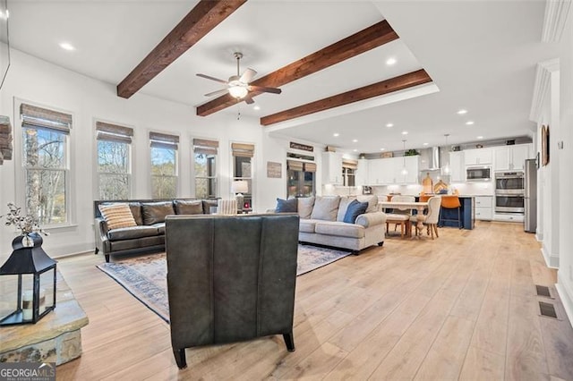 living room with beam ceiling, ceiling fan, and light hardwood / wood-style flooring