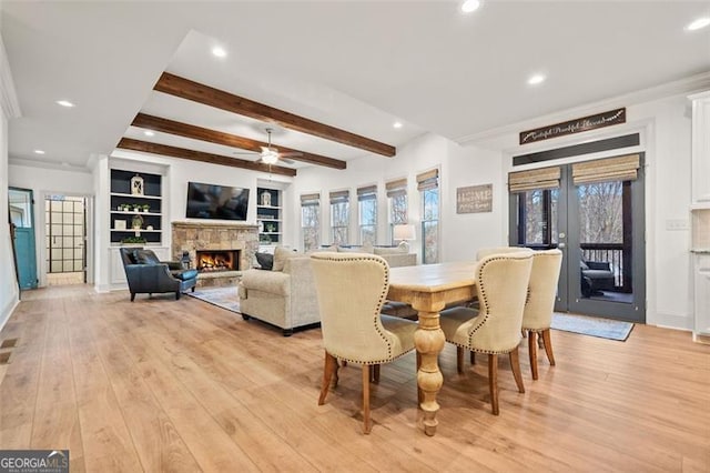 dining area with ceiling fan, light hardwood / wood-style floors, beam ceiling, and a wealth of natural light