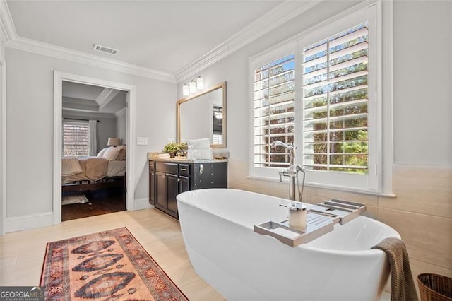 bathroom with a washtub, a wealth of natural light, and ornamental molding