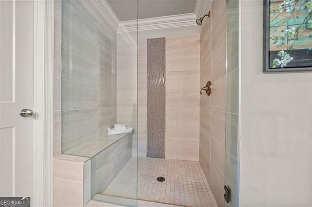 bathroom featuring a shower with door and crown molding