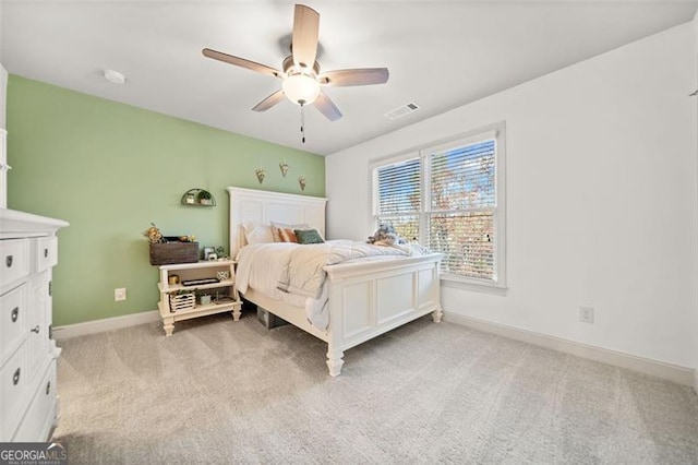 bedroom featuring ceiling fan and light carpet