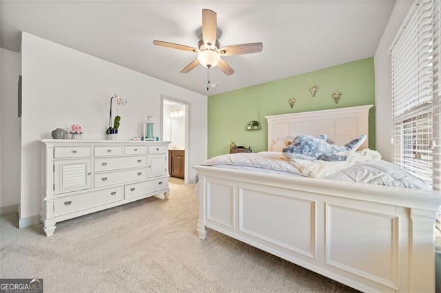 carpeted bedroom with connected bathroom and ceiling fan