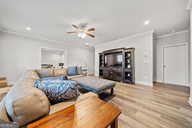 living room with light wood-type flooring, ceiling fan, and crown molding