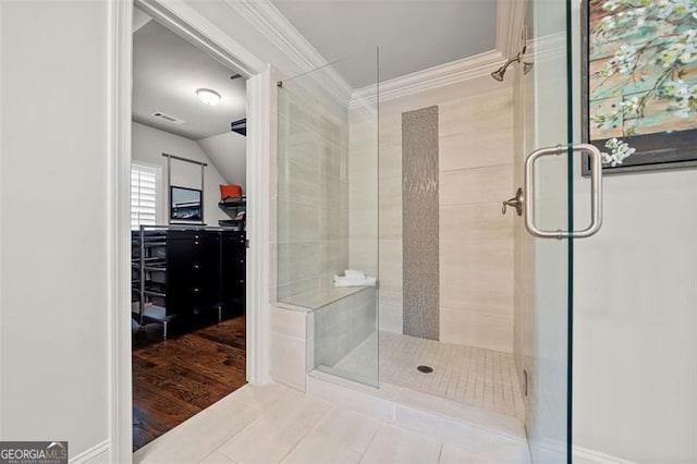 bathroom featuring an enclosed shower, wood-type flooring, crown molding, and vaulted ceiling