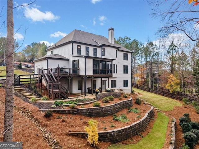 rear view of property with a wooden deck