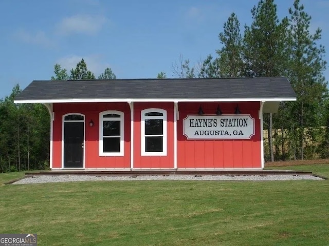 view of outbuilding featuring a lawn