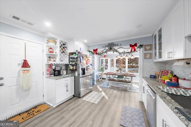 kitchen featuring white cabinetry, stainless steel appliances, light stone counters, light hardwood / wood-style flooring, and crown molding