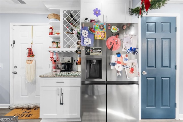 kitchen featuring stainless steel fridge with ice dispenser, white cabinets, light stone counters, and ornamental molding