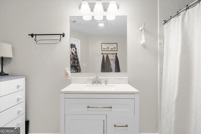 bathroom featuring curtained shower and vanity