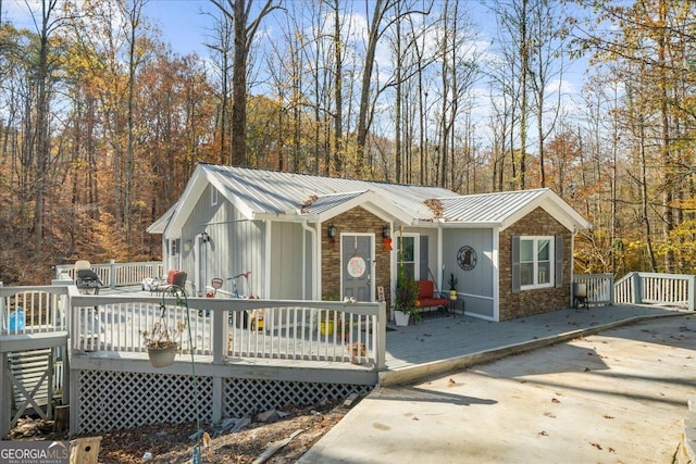 173 Mountainside Dr E, Dawsonville, GA 30534 - ranch-style house featuring stone siding, metal roof, and a wooden deck