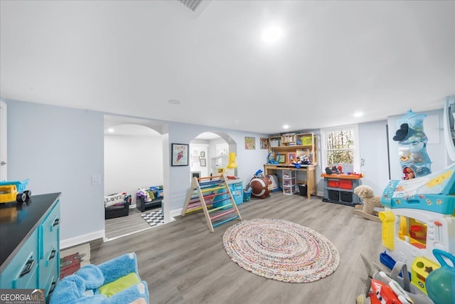 game room with light hardwood / wood-style flooring