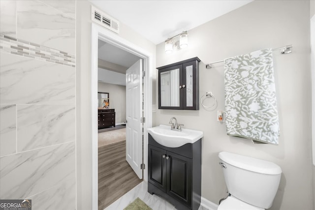 bathroom featuring hardwood / wood-style floors, vanity, and toilet