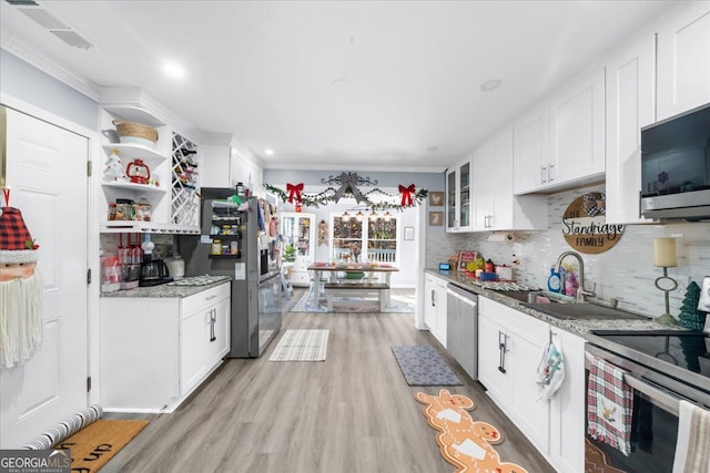 kitchen featuring white cabinetry, light stone counters, and appliances with stainless steel finishes