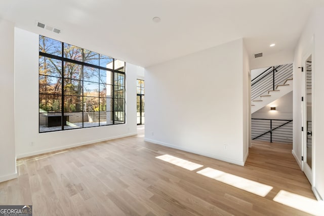 unfurnished room with light hardwood / wood-style floors