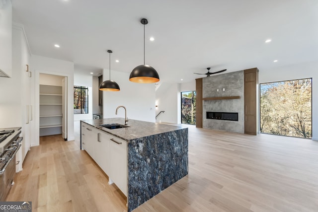 kitchen featuring white cabinetry, sink, pendant lighting, and plenty of natural light