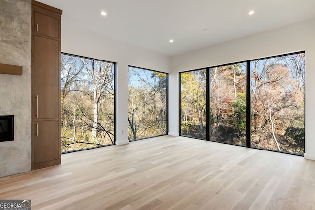 unfurnished sunroom with a large fireplace