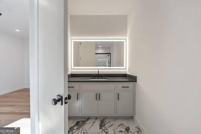 bathroom with hardwood / wood-style floors and vanity