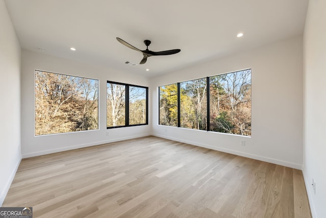 empty room with ceiling fan and light wood-type flooring