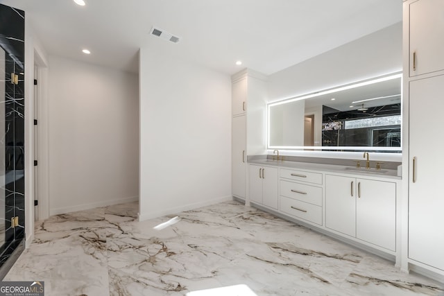 bathroom featuring vanity and a shower with door