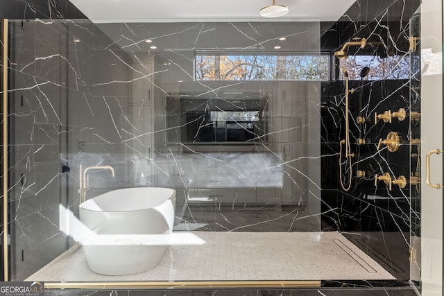 bathroom featuring a shower with door and tile walls