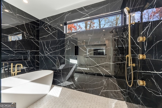 bathroom with tiled shower and tile walls