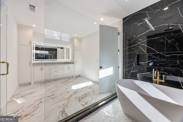 bathroom featuring vanity and a bath