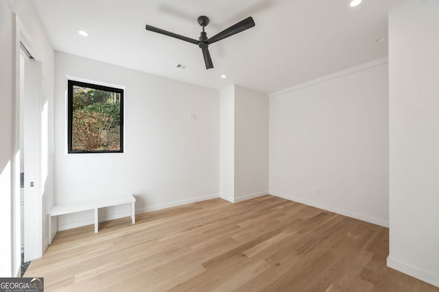 spare room with ceiling fan and light hardwood / wood-style floors