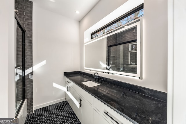 bathroom with a shower with door and vanity