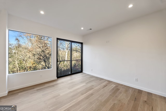 unfurnished room featuring light hardwood / wood-style flooring