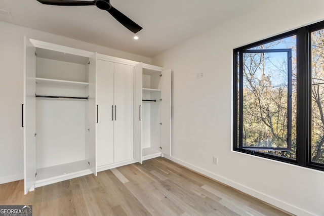 unfurnished bedroom with ceiling fan and light hardwood / wood-style floors