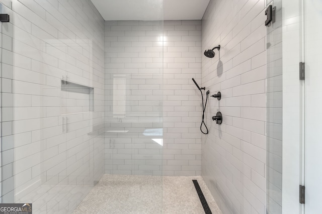 bathroom with tiled shower