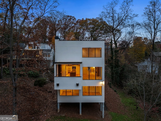 view of back house at dusk