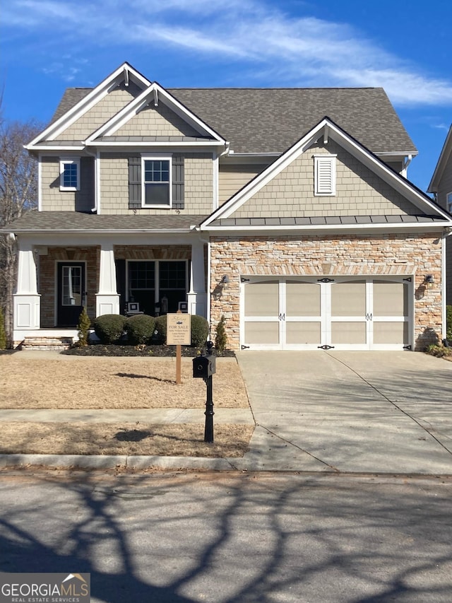 craftsman-style home featuring a garage and a porch