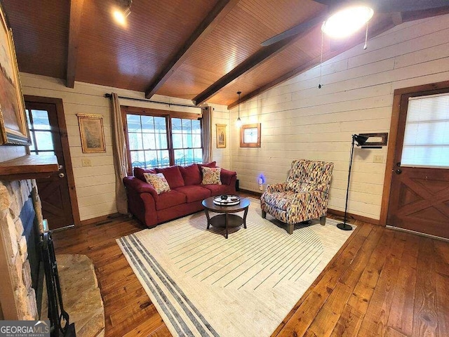 living room featuring lofted ceiling with beams, dark hardwood / wood-style flooring, wood ceiling, and wooden walls