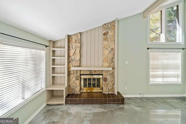 unfurnished living room featuring a fireplace and vaulted ceiling