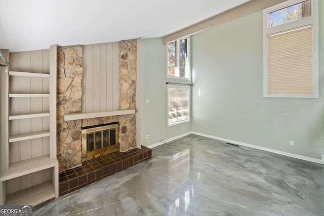 unfurnished living room featuring a fireplace and concrete floors