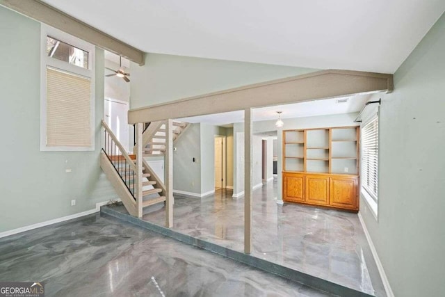 spare room featuring ceiling fan and lofted ceiling with beams