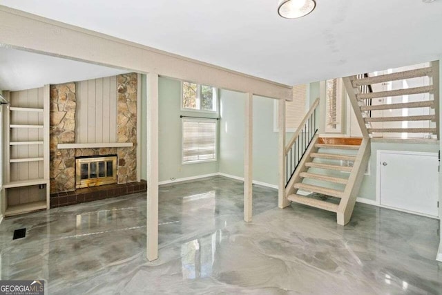 basement with a stone fireplace