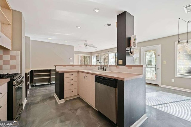 kitchen featuring ceiling fan, stainless steel appliances, a wealth of natural light, and sink