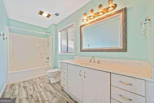 full bathroom with vanity, wood-type flooring,  shower combination, and toilet