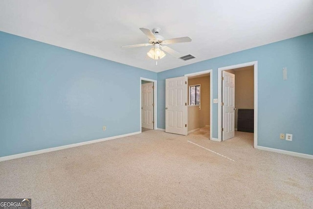 unfurnished bedroom featuring ceiling fan and light colored carpet