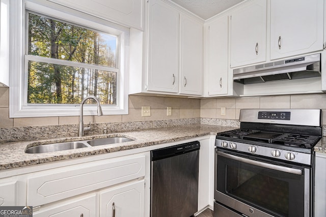 kitchen featuring backsplash, white cabinets, sink, light stone countertops, and appliances with stainless steel finishes