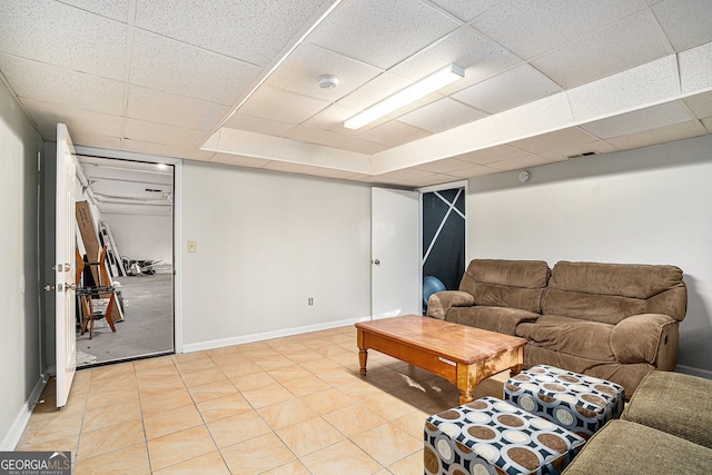 living room featuring a drop ceiling