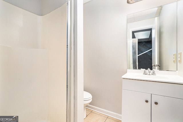 bathroom featuring tile patterned flooring, vanity, and toilet