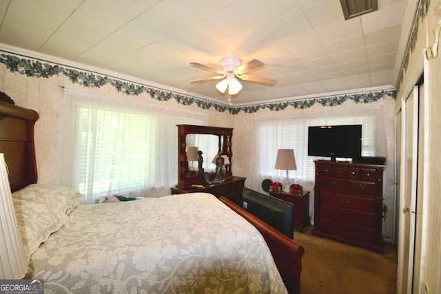 bedroom featuring ceiling fan, carpet, and ornamental molding